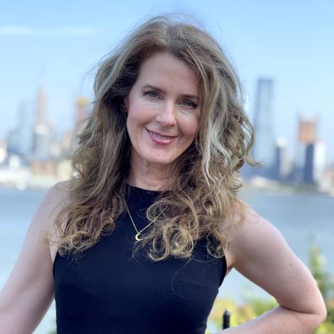 Lisa Loud smiling face on with a city in the background