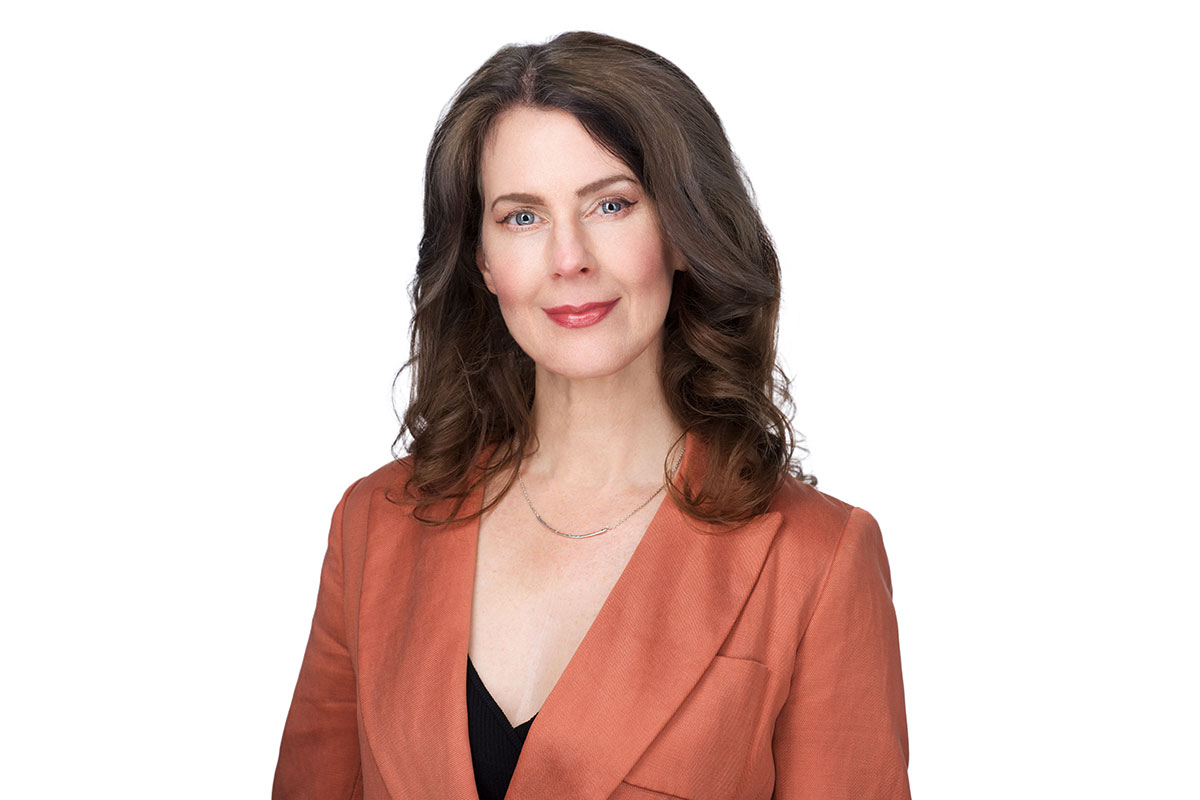 Lisa Loud smiling in an orange blazer and black shirt